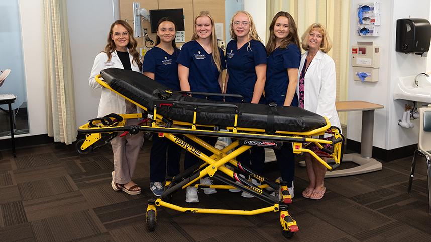 Nursing faculty and students with new Stryker Stretcher 858